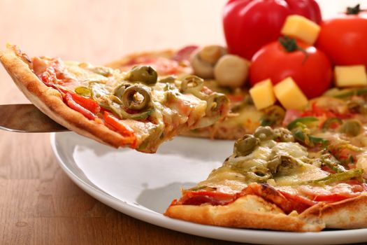 Fresh italian pizza in plate on a wooden surface