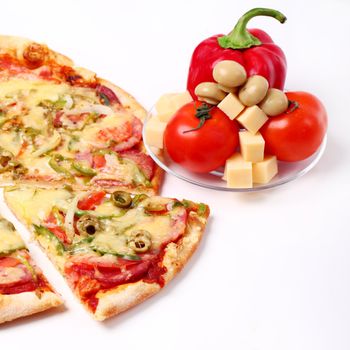 Image of sliced pizza and vegetables isolated over white background