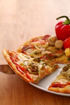 Fresh italian pizza in plate on a wooden surface