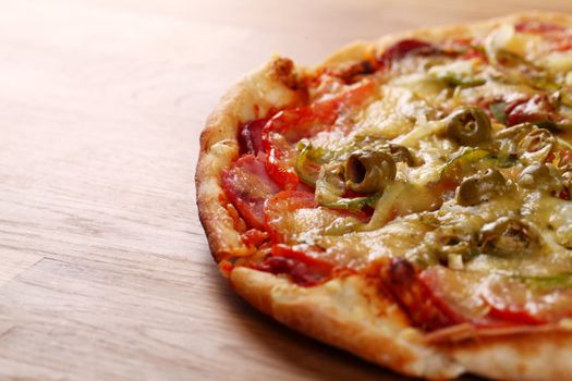 Image of fresh italian pizza on a wooden suface