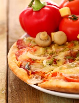 Fresh italian pizza in plate on a wooden surface