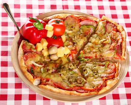 Image of fresh italian pizza on a squared tablecloth