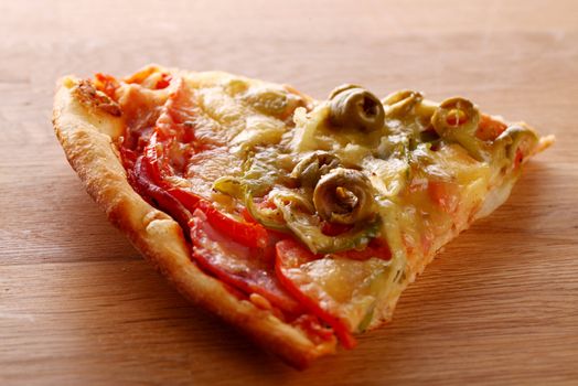 Slice of fesh italian pizza over wooden background