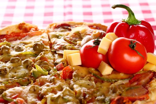 Image of fresh italian pizza on a squared tablecloth