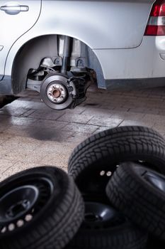 inside a garage - changing wheels/tires (shallow DOF; color toned image)