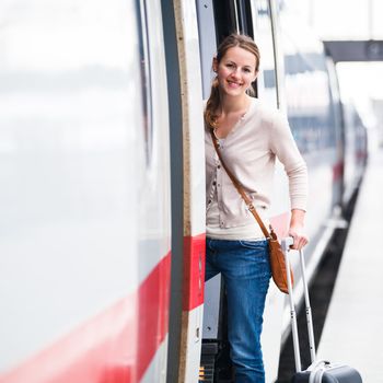 Pretty young woman boarding a train