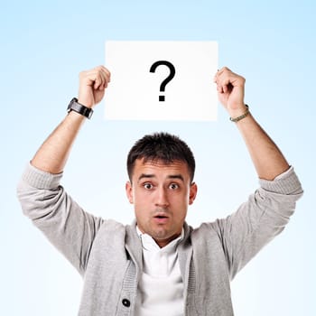 Young handsome man holding blank board ready for text on white background