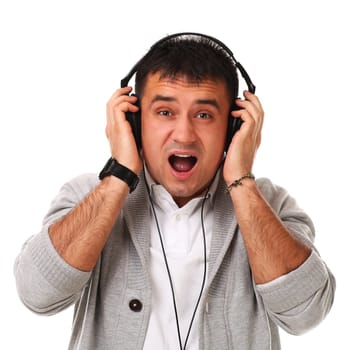 Young caucasian handsome man listening music isolated over white background