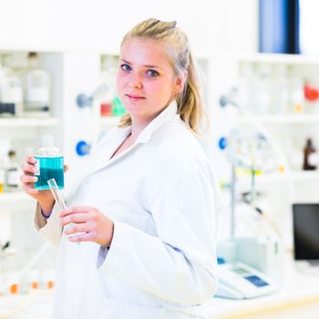 Portrait of a female researcher carrying out research in a chemistry lab (color toned image; shallow DOF)