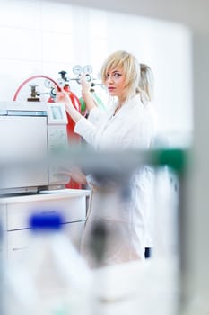 Two female researchers working in a laboratory (color toned image)