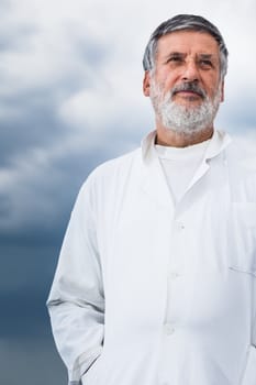 Renowned scientist/doctor standing on the roof of the research center/hospital looking confident (color toned image)