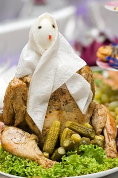 Beautifully decorated chicken on a plate with lettuce and cucumber