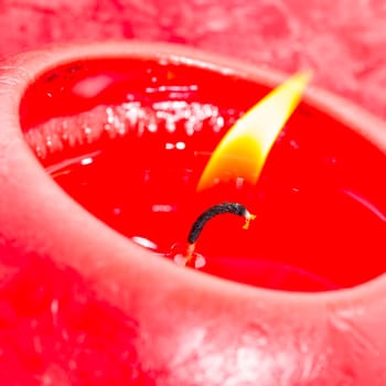 Close-up of a red candle, bright flame