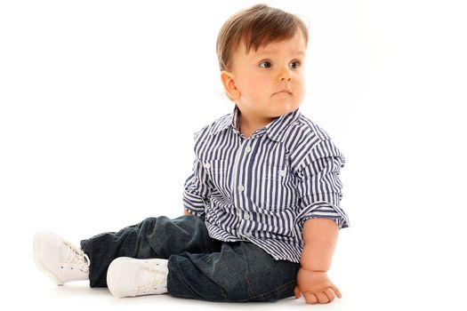 Beautiful serious little boy in jeans isolated over white background