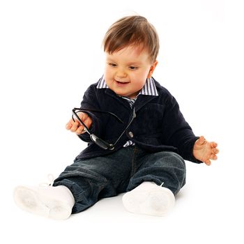 Beautiful serious little boy in a coat and jeans isolated over white background