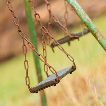 Closeup of swings in a children play area at park