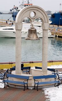 Ships old bronze bell in the seaport
