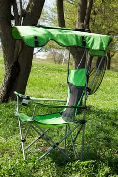 Fisherman's (working) chair  against a background of green grass