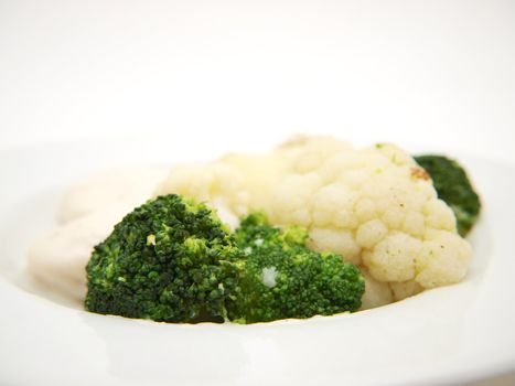 Broccoli and cauliflower isolated on white plate, towards white background
