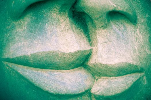 Detail of stonework sculpture of human mouths with sensual lips ready to kiss.