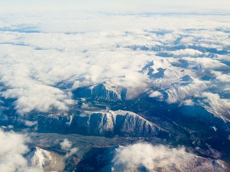 Aerial view of snowcapped mountains in northern part of the province of beautiful British Columbia, Canada.