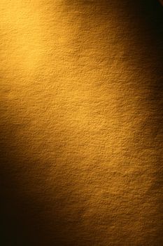 Old yellow paper surface with beam of light. Good background for your text