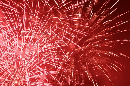 red holiday fireworks in night sky