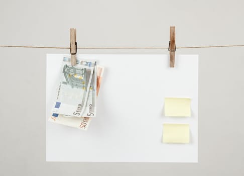 Memory note paper with Euro moneys hanging on cord
