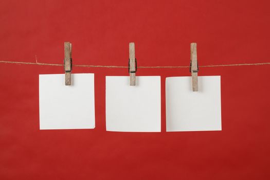 memory note paper hanging on cord on red background