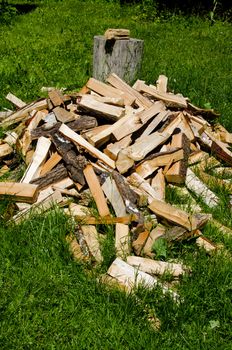 Pile of chopped wood on meadow