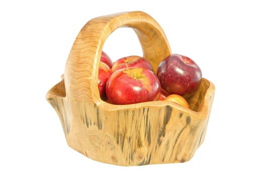 A wooden basket full of apples isolated on white background