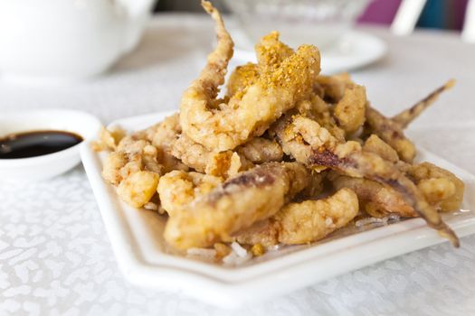 Plate of fried calamari served with sauce