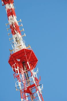 The metal television antenna against a blue clear sky.