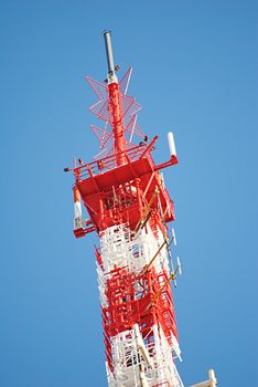 The metal television antenna against a blue clear sky.