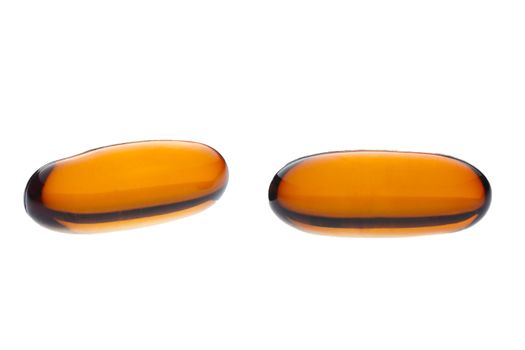 Two vitamin E pills isolated on a white background