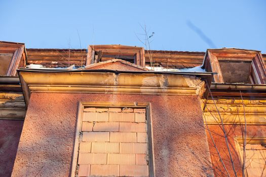 Abandoned house sealed with bricks in winter