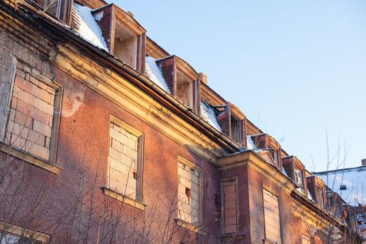 Abandoned house sealed with bricks in winter