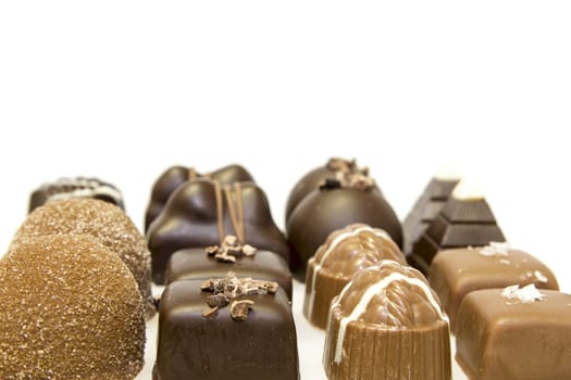 Rows of Chocolate Assortment with Truffles Dark Milk Salt Nut Isolated on White Background