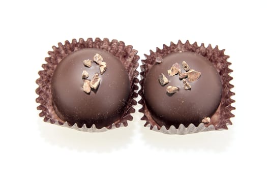 Two Dark Gourmet Chocolate Truffles Isolated on White Background
