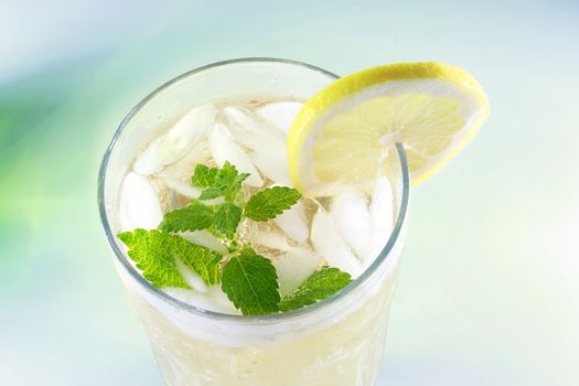 Ice-cold Lemonade with fresh slice of lemon and lemon balm (mint)