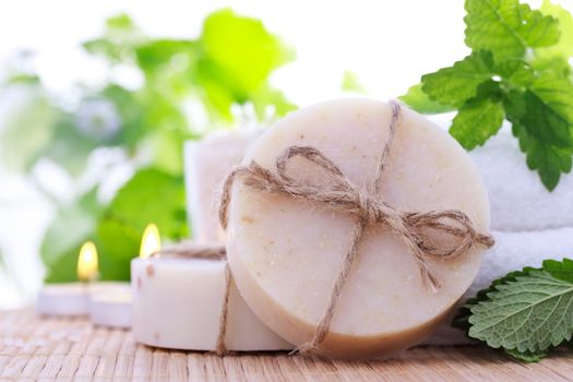 Bars of soap with fresh mint leaves and towels