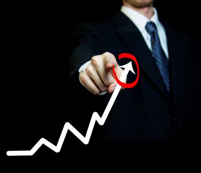 Businessman highlighting business growth on a graph