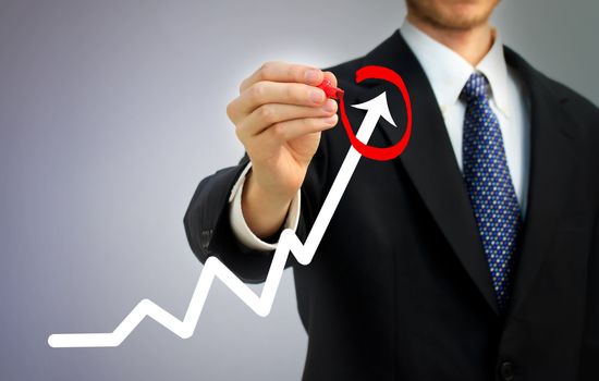 Businessman highlighting business growth on a graph