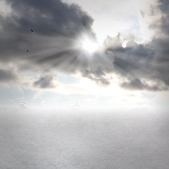 Gray clouds and sunbeams with open land