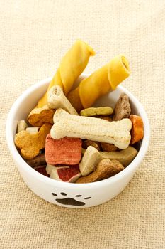 Dog food in dog bowl on burlap cloth