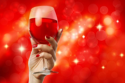 Woman holding a wine glass on a red abstract background