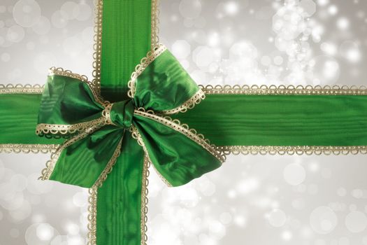 Green Bow and Ribbon with Silver Bokeh Lights Background 