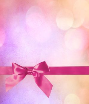 Pink Bow and Ribbon with Abstract Lights Background 