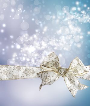 White Snowflake Bow and Ribbon with Bokeh Lights Background 