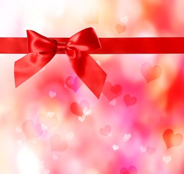 Red bow and ribbon with hearts background 